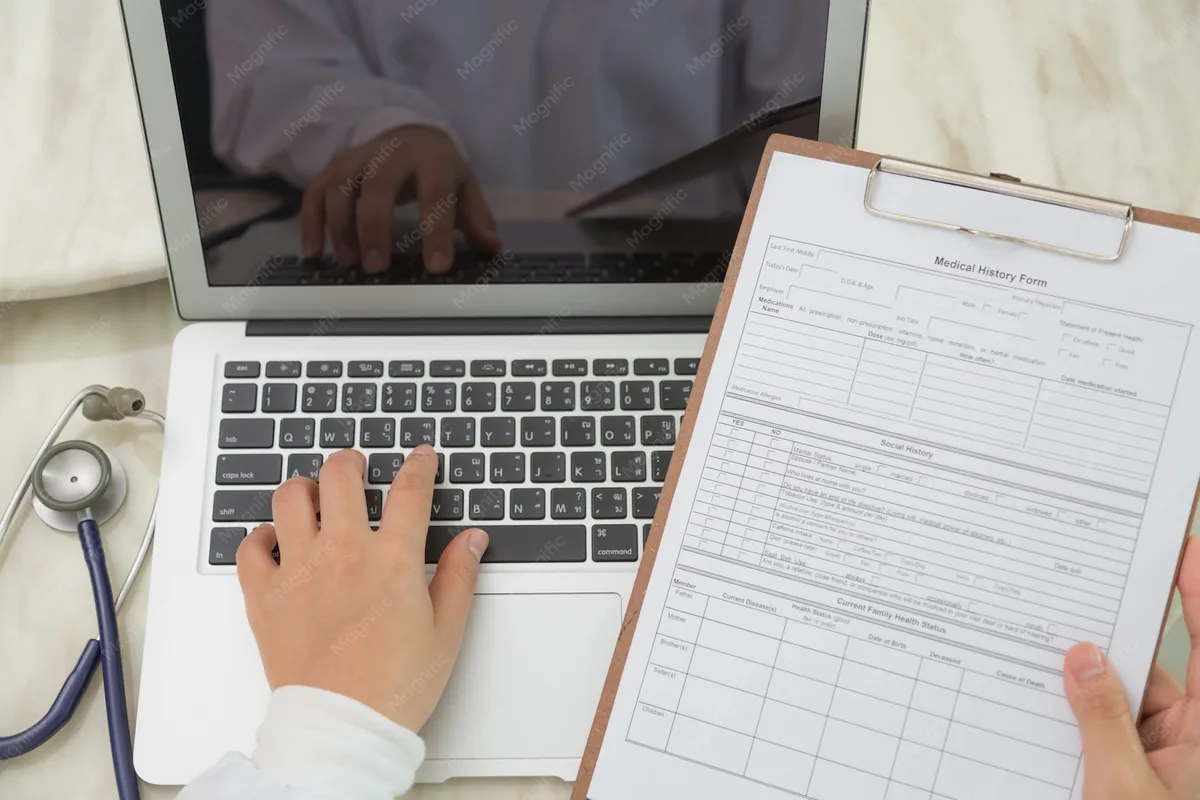 Assessing medical billing workflows on laptop and clipboard