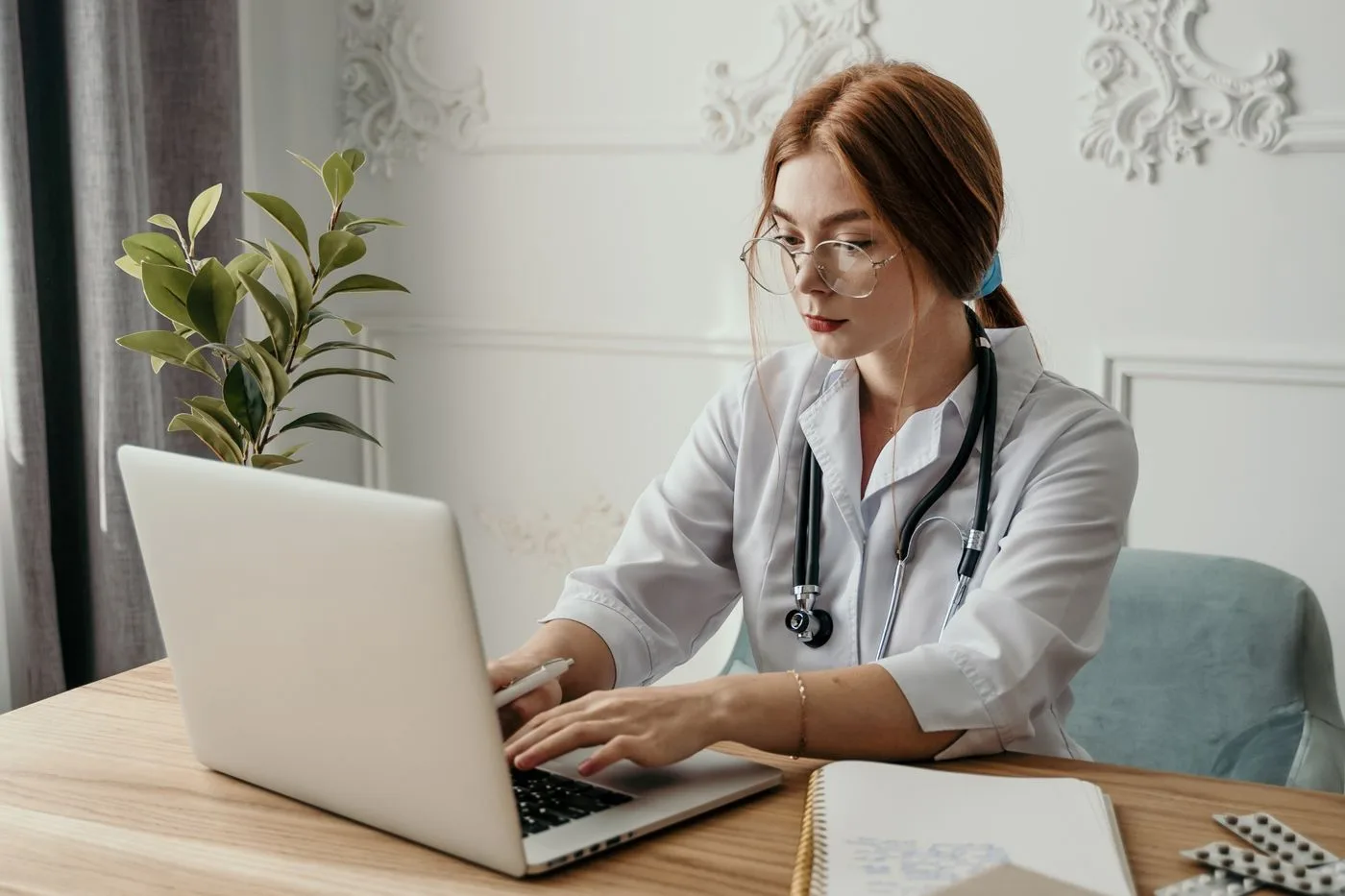 Doctor preparing billing readiness on a laptop